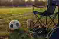 Soccer ball and sideline chair on the grass